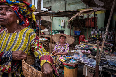 People sitting at market stall