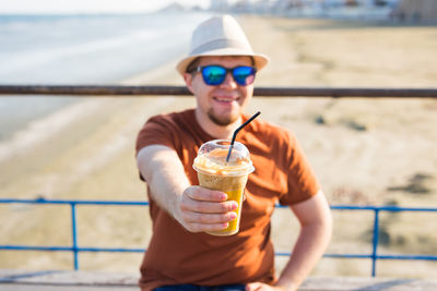 Portrait of smiling man holding ice cream