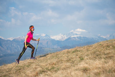 Woman against mountain range against sky