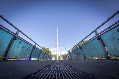 Surface level shot of bridge against blue sky