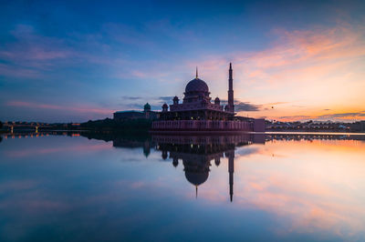 Silhouette of church in front of river