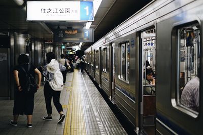 Rear view of people at railroad station