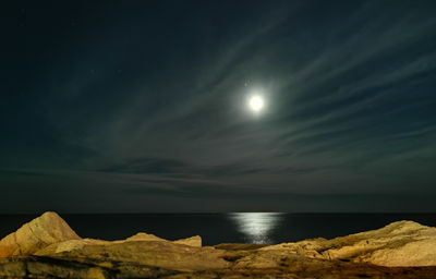 Scenic view of sea against sky at night