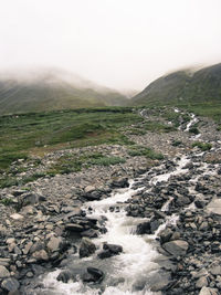 Scenic view of river flowing through rocks