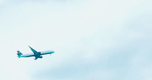 Low angle view of airplane flying against clear sky