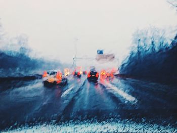 Panoramic view of cars on snow covered landscape