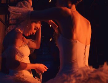 Ballet dancers in dark at backstage