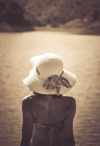 Rear view of woman standing against sea