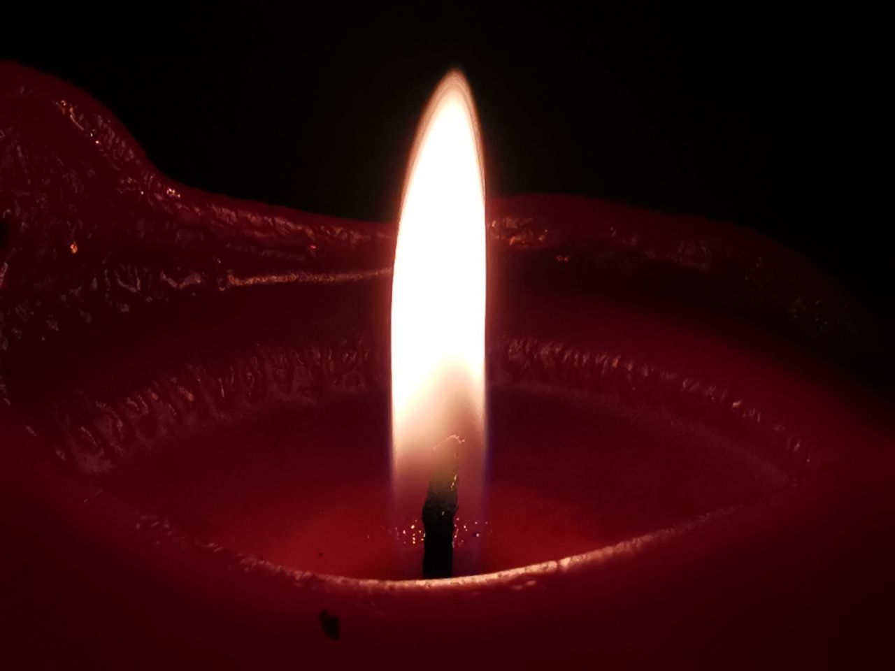 CLOSE-UP OF BURNING CANDLE