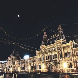 Low angle view of illuminated building during christmas at night