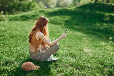 Rear view of woman using mobile phone