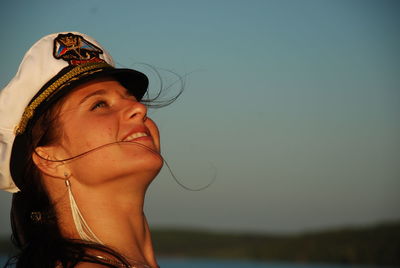 Close-up of woman wearing sailor hat looking up