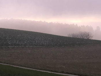 Scenic view of field against sky during sunset