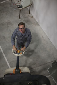 Warehouseman in storehouse working with pallet jack