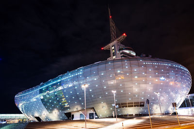 Low angle view of illuminated building against sky at night