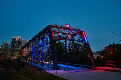 Low angle view of bridge against clear blue sky