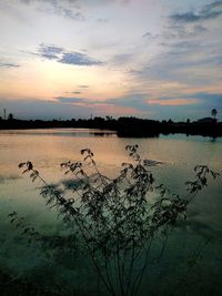 Scenic view of lake against sky during sunset