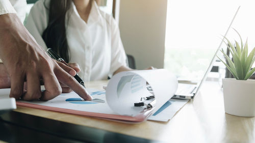 Midsection of woman working on table