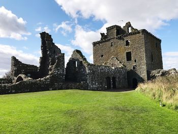 View of old ruin building against cloudy sky