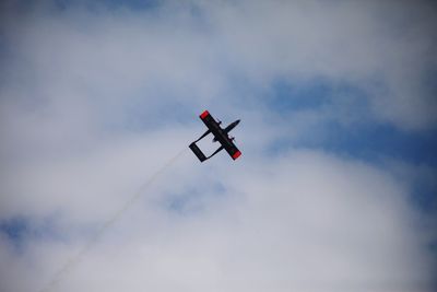 Low angle view of airplane flying against sky