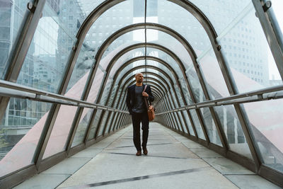 Rear view of man standing in tunnel