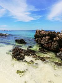 Rocks on beach against sky