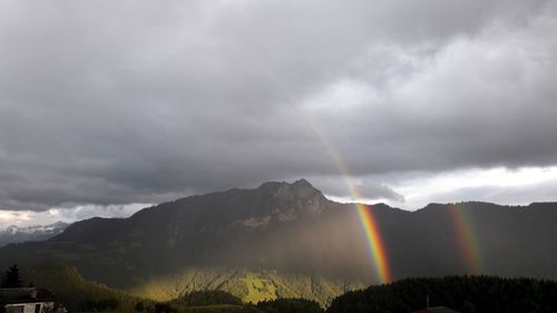 Rainbow over mountain against sky