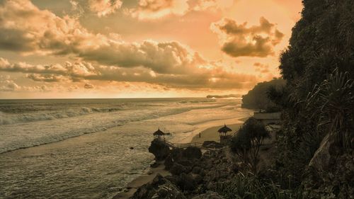 Scenic view of beach against sky during sunset