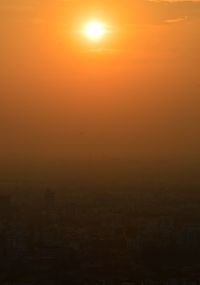 Silhouette cityscape against sky during sunset