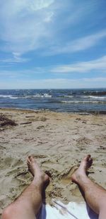 Low section of woman relaxing on beach