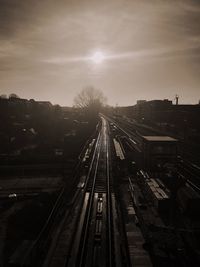 Railroad tracks against sky at night