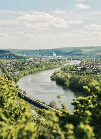 High angle view of river amidst trees against sky