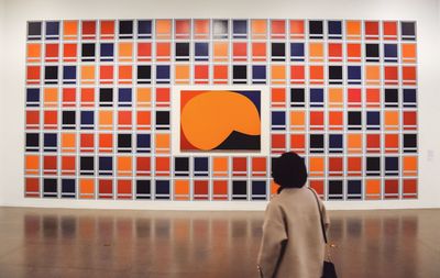 Rear view of a man standing against building