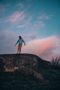 Full length of man standing on land against sky