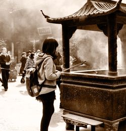 Rear view of woman standing at music concert