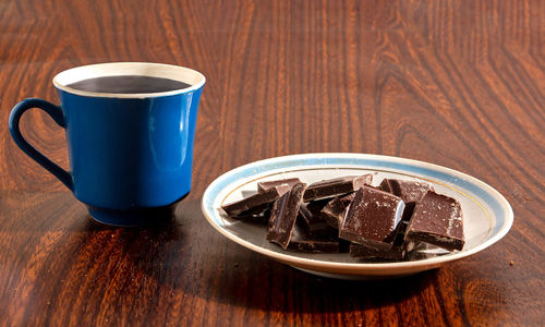 Pieces of chocolate and a cup of coffee