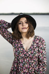 Portrait of a beautiful young woman standing outdoors