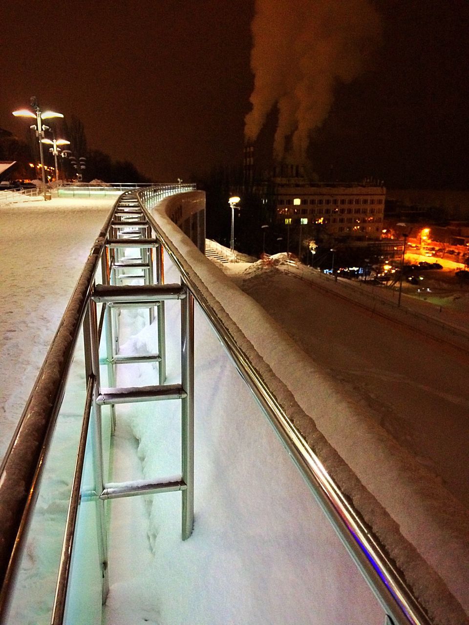 architecture, built structure, night, high angle view, city, transportation, railing, outdoors, illuminated, building exterior, no people, sky