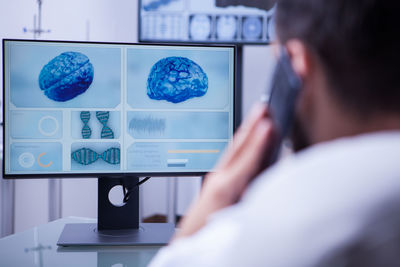 Side view of woman using laptop at home