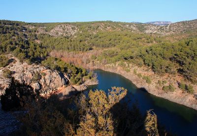 High angle view of river amidst trees against sky