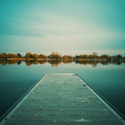 Pier over lake against sky