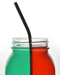 Close-up of glass bottle against white background