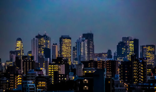 Illuminated buildings in city at night