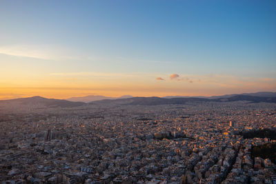 Sunset in athens on a cloudy sky with a city view from lycabettus hill in athens greece