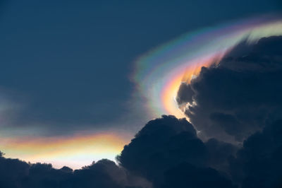 Low angle view of rainbow against sky during sunset