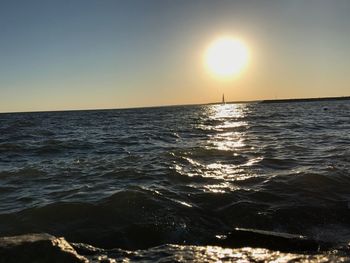 Scenic view of sea against clear sky during sunset