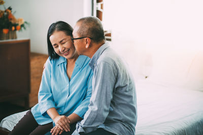 Man and woman sitting at home