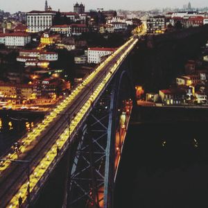 High angle view of illuminated city against sky at night