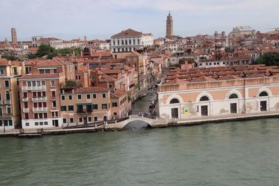 Bridge over river against buildings in city