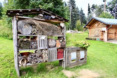 Built structure on field by house in forest